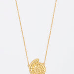 gold fossil pendant on thin chain necklace