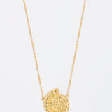 gold fossil pendant on thin chain necklace