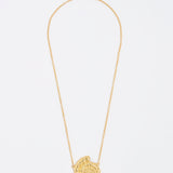 gold fossil pendant on thin chain necklace
