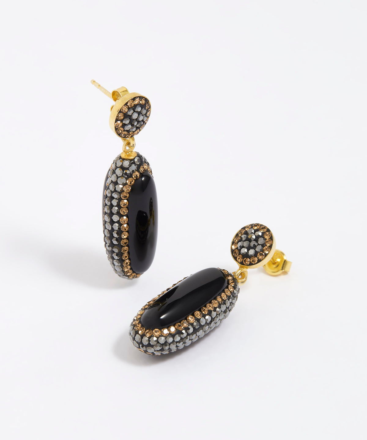 Pair of earrings with black and gold design on a white background