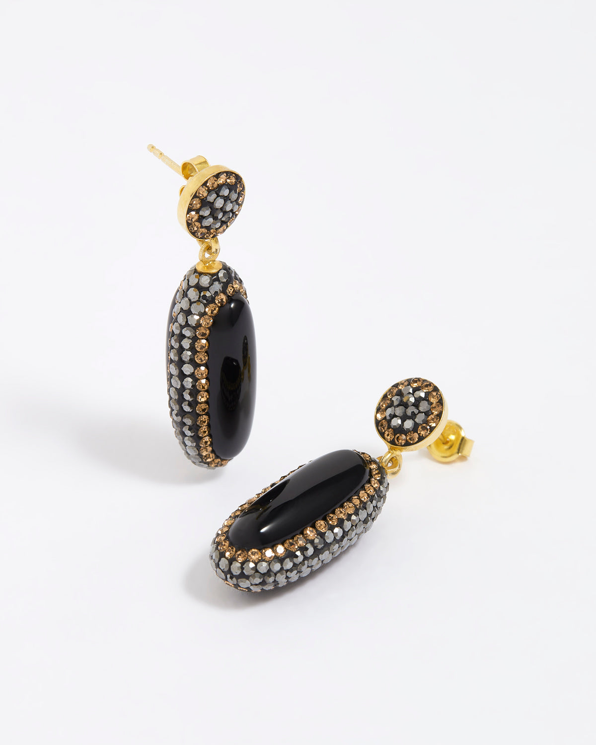 Pair of earrings with black and gold design on a white background
