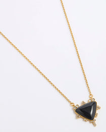 A gold chain necklace featuring a triangular black onyx pendant with small clear crystal accents in a gold setting, displayed on a white background.