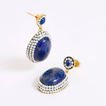 A pair of gold-toned drop earrings featuring large oval lapis lazuli stones surrounded by rows of small opal stones, with smaller matching stud earrings above, photographed on a white background.