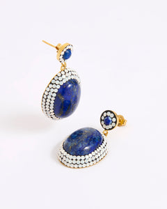 A pair of gold-toned drop earrings featuring large oval lapis lazuli stones surrounded by rows of small opal stones, with smaller matching stud earrings above, photographed on a white background.