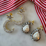 Pair of pearl earrings and crystal moon and star earrings