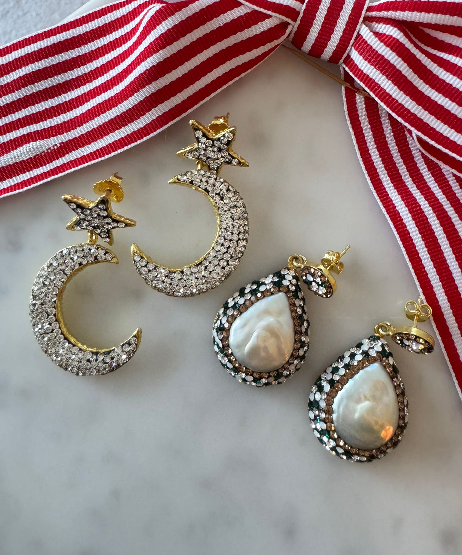 Gold and silver moon and star earrings .