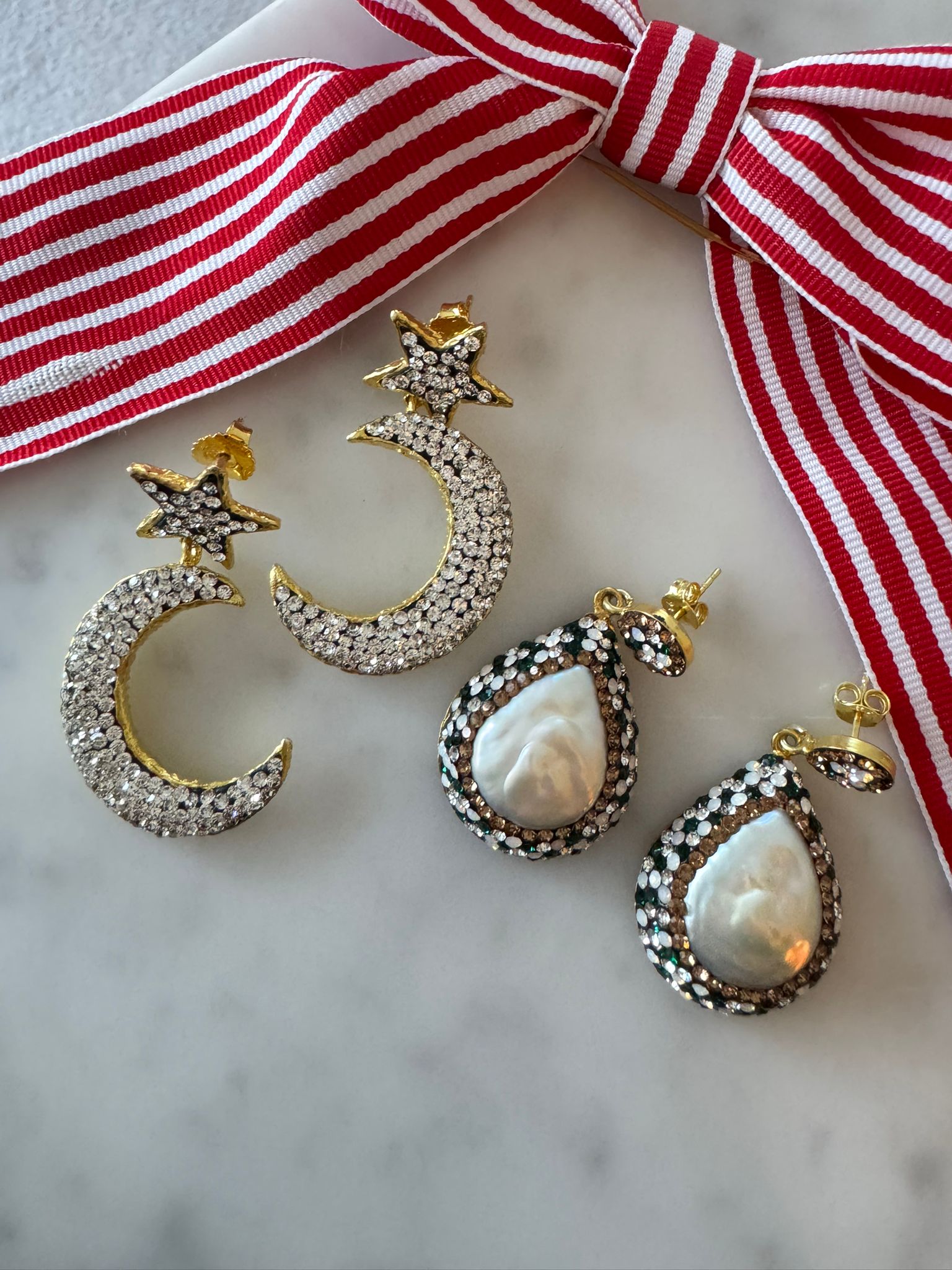 Gold and silver moon and star earrings .