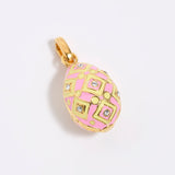 Pink, yellow and gold egg-shaped pendant on a light gray background