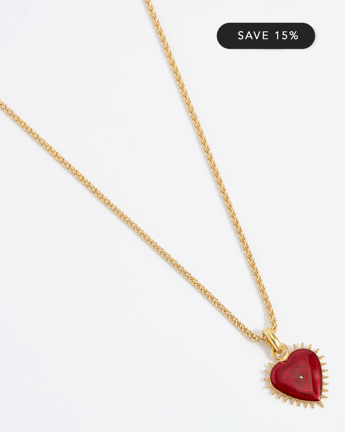 Product shot of Soru Jewellery red heart charm hung from a rope charm chain on white background
