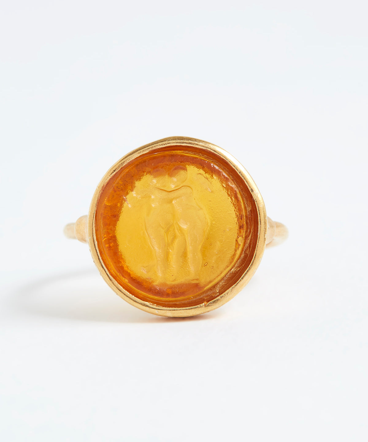 Gold ring with a circular design on a white background
