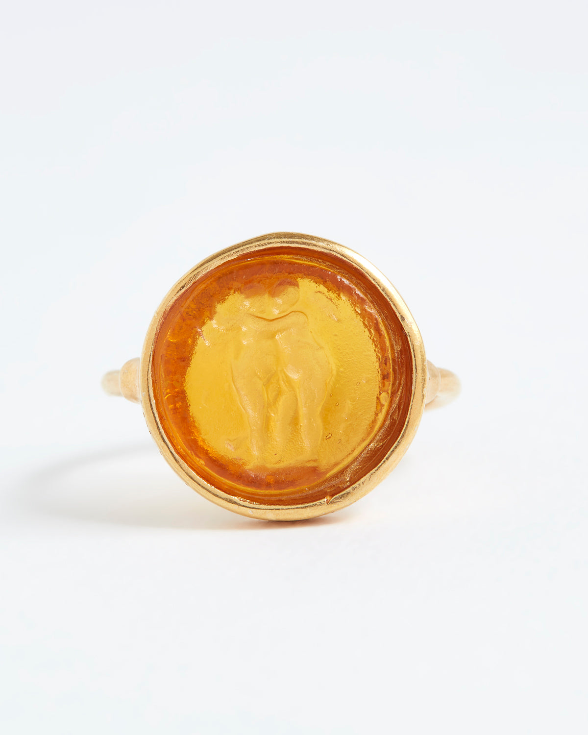 Gold ring with a circular design on a white background