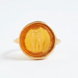 Gold ring with a circular design on a white background