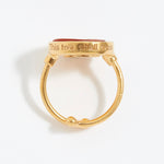 Gold ring with 'This too shall pass' engraving on a white background