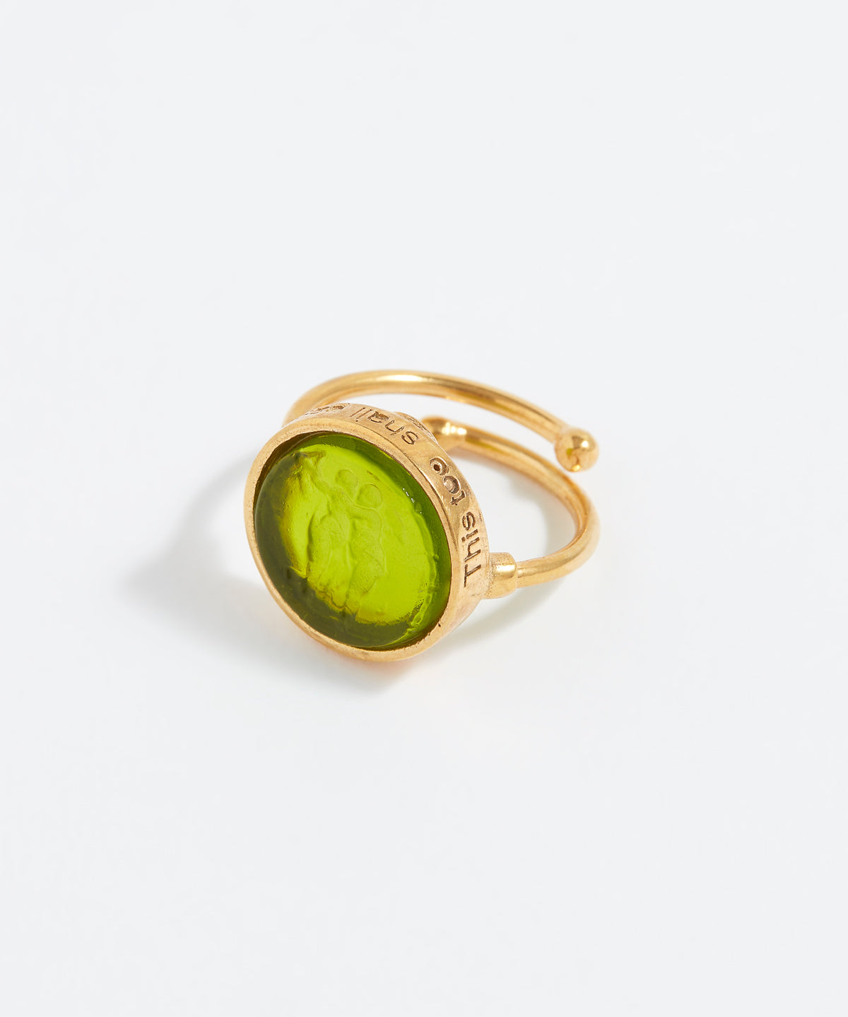 Gold ring with a green stone on a white background