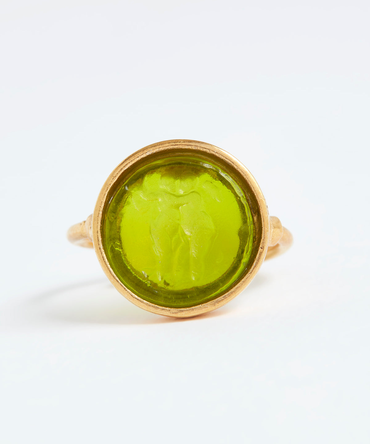 Gold ring with a green stone on a white background