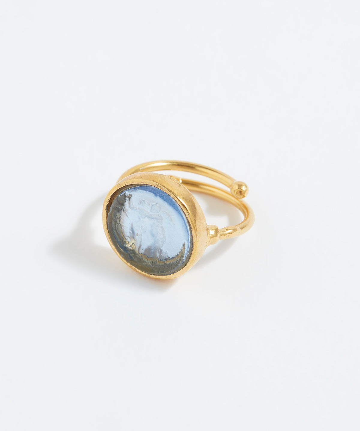 Gold ring with a blue stone on a white background