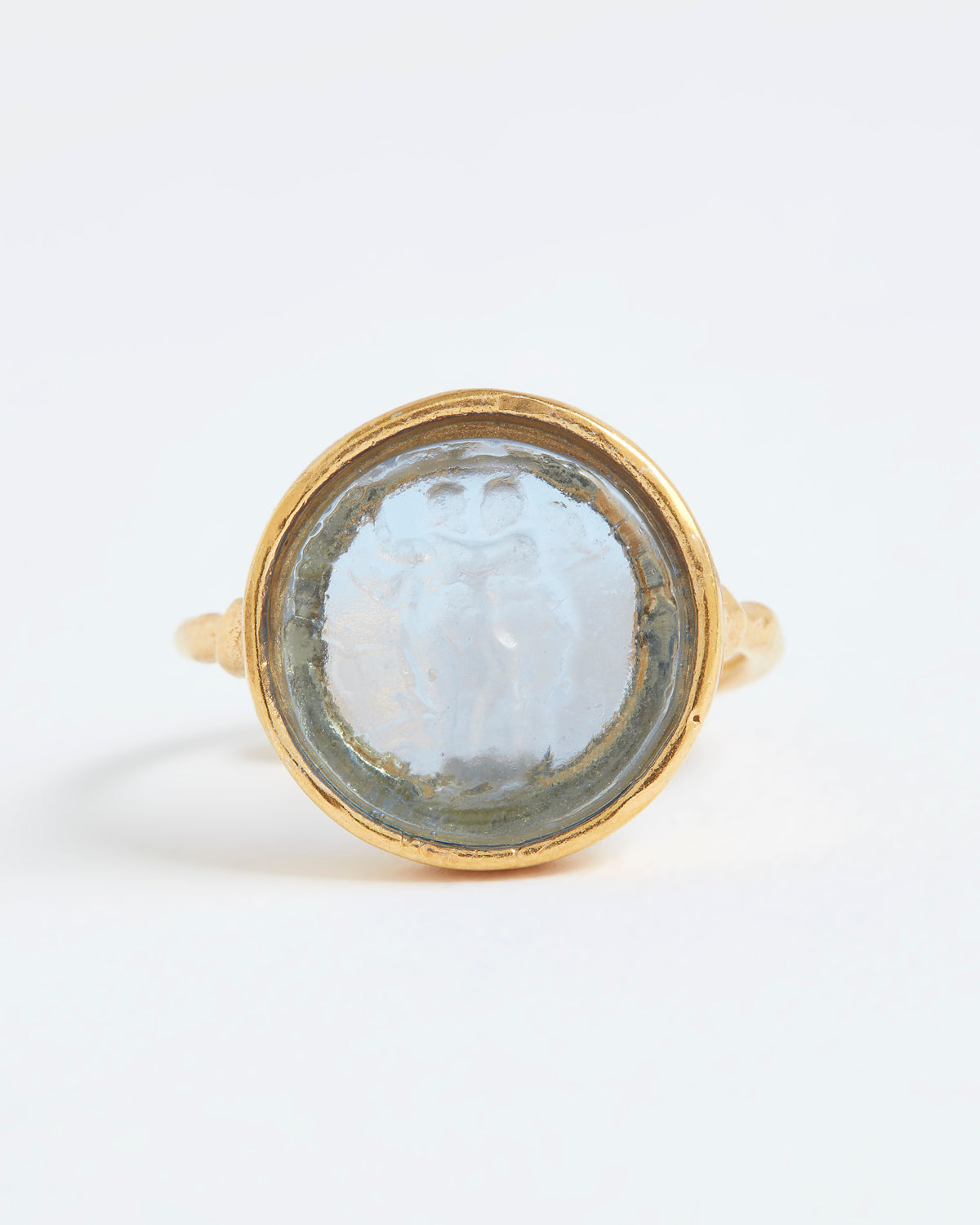 Gold ring with a circular stone on a white background