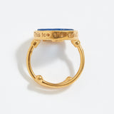 Gold ring with blue stone with "This Too Shall Pass" engraved on a white background
