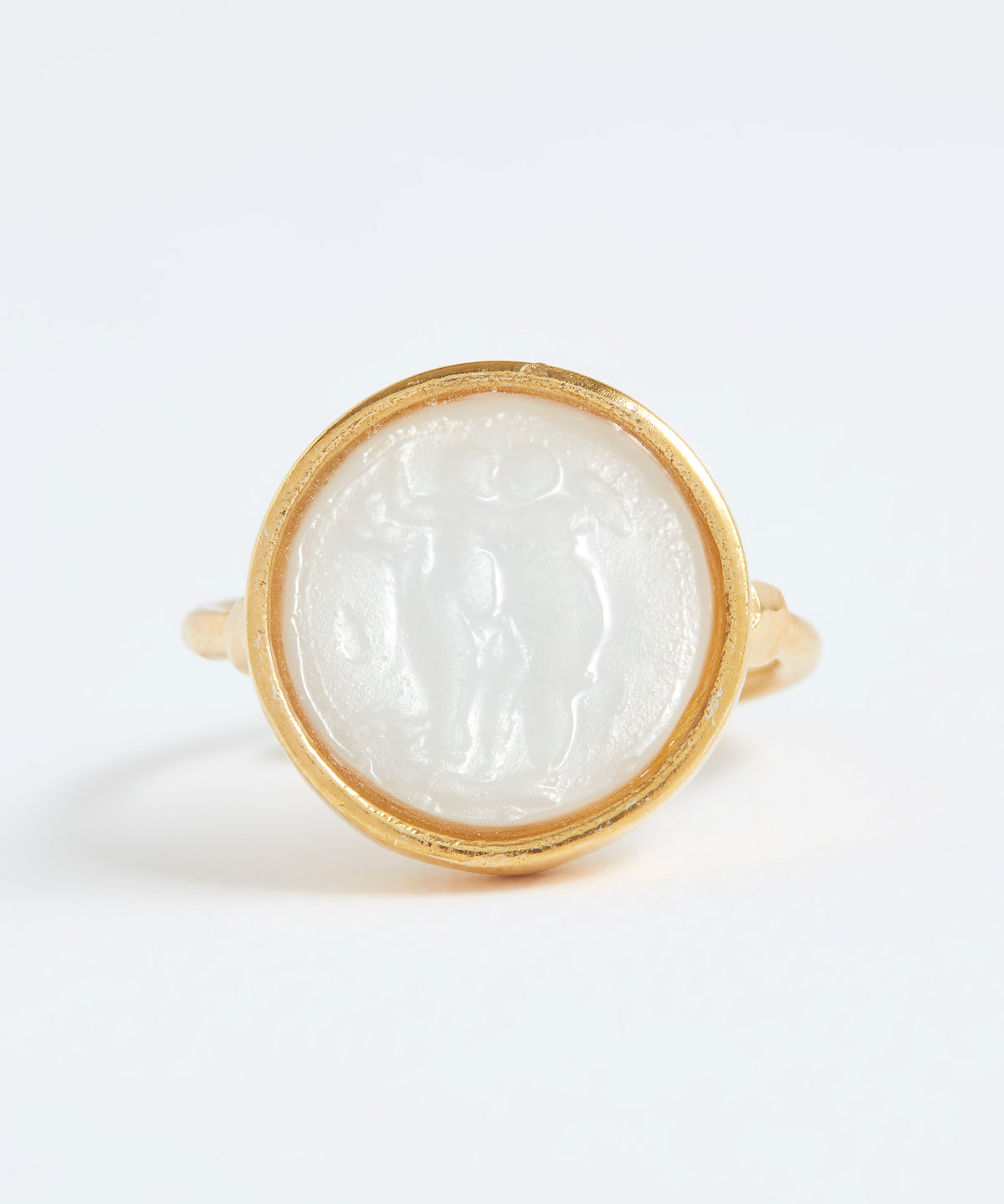 Gold ring with a white stone inlay on a white background