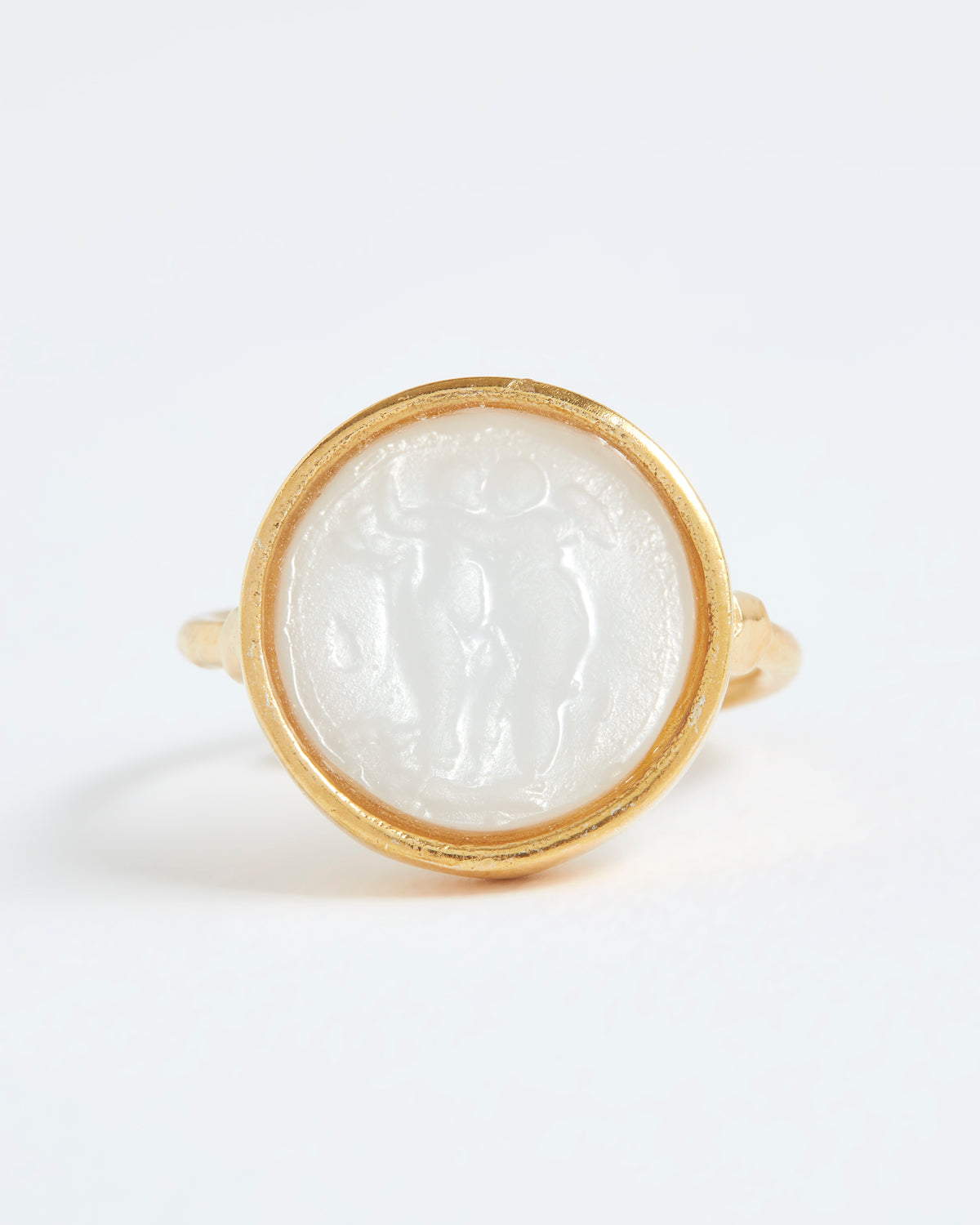 Gold ring with a white stone inlay on a white background