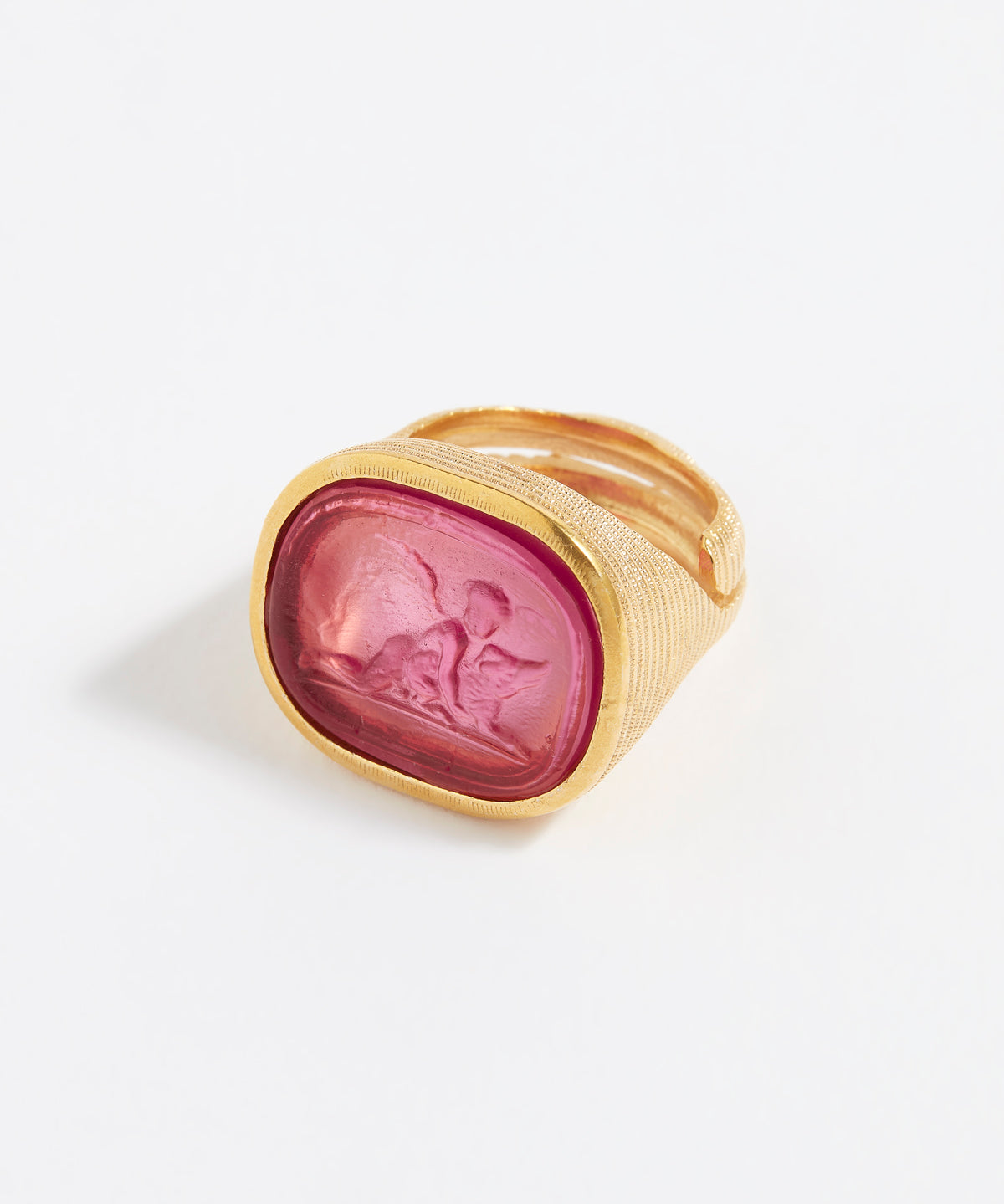 Gold ring with a pink stone on a white background