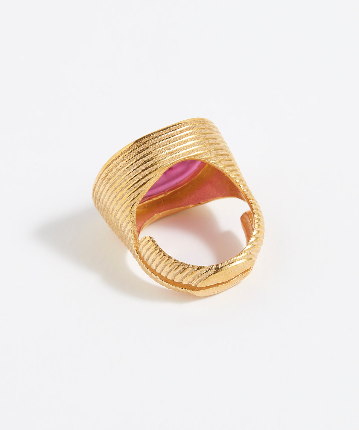 Gold ring with pink centre on a white background