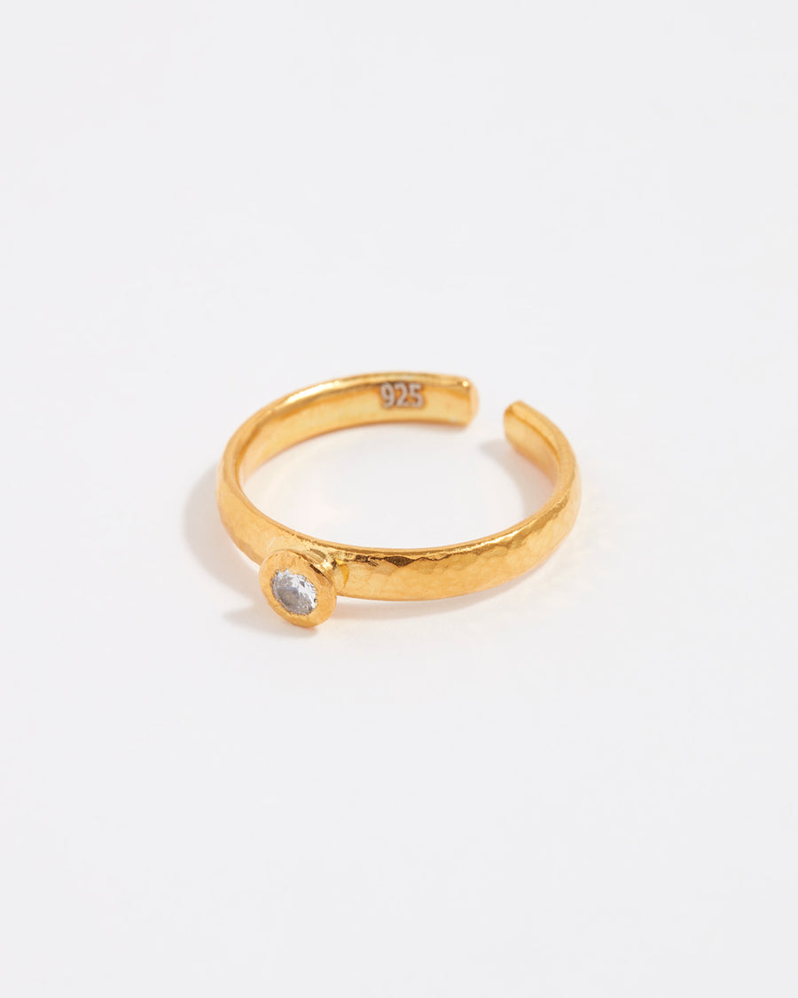 gold solitaire ring with singular crystal in centre