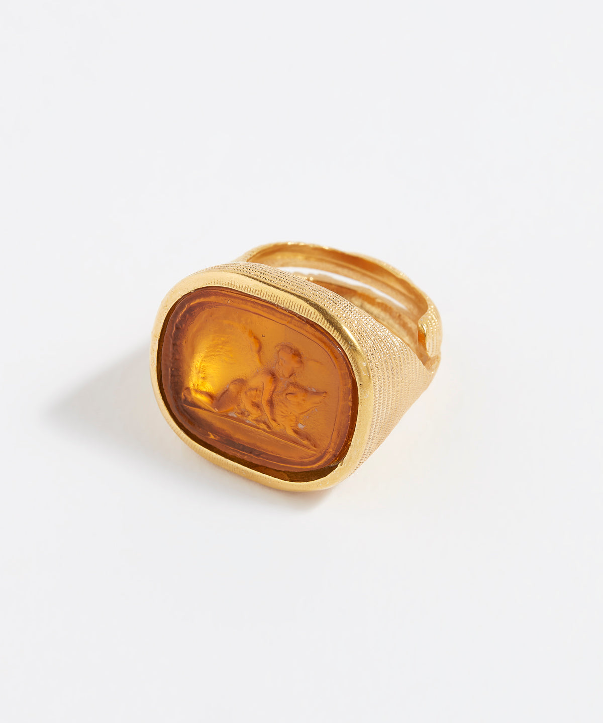 Gold ring with a engraved design on a white background