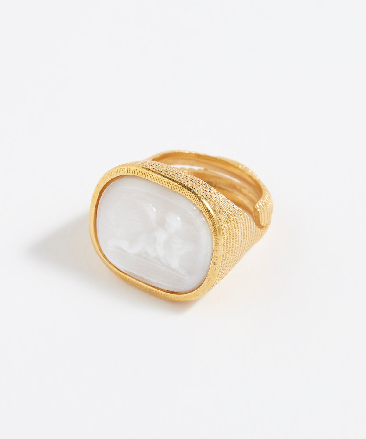 Gold ring with a white stone on a white background
