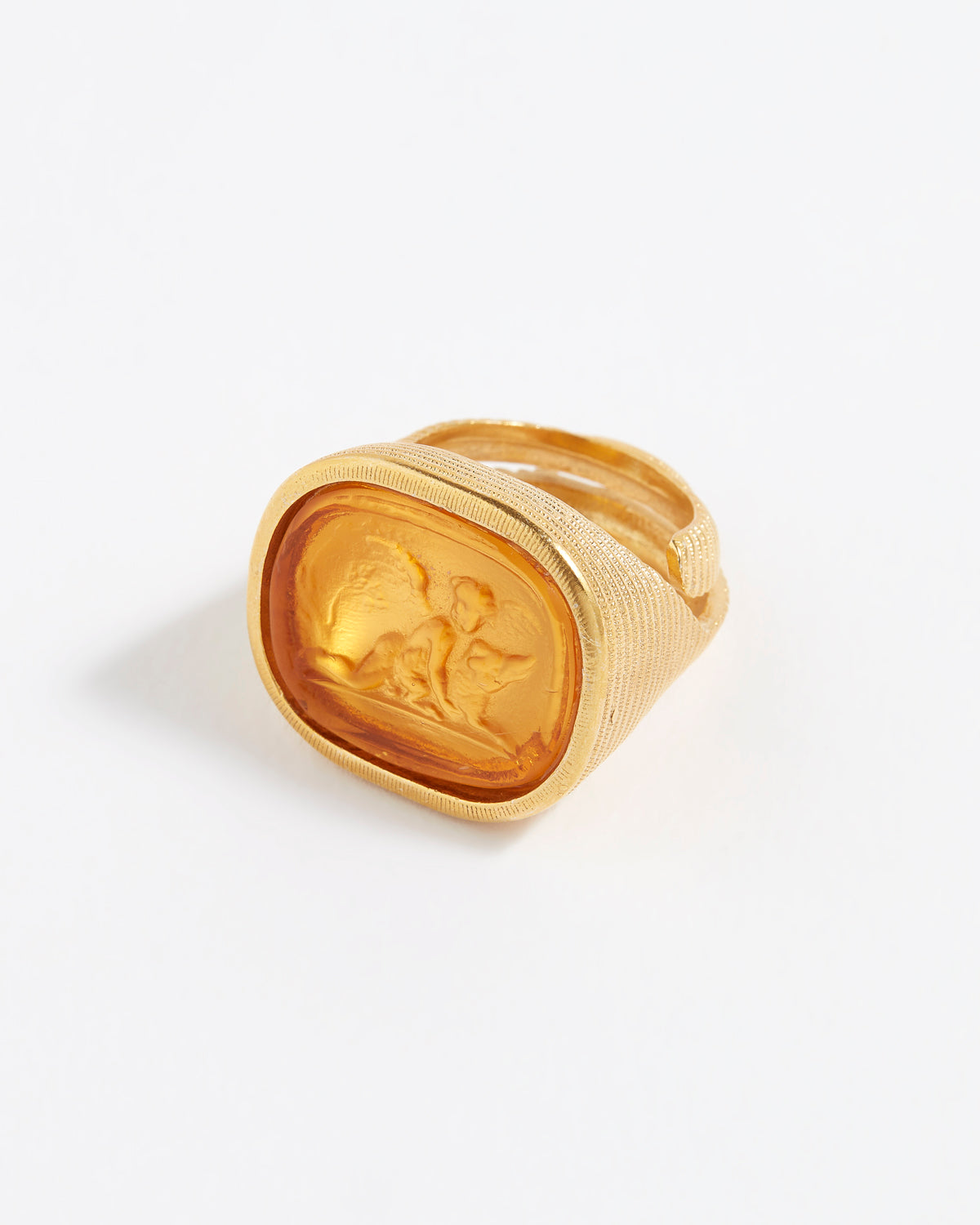 Gold ring with a cherub design on a white background