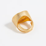 Gold ring with textured design on a white background