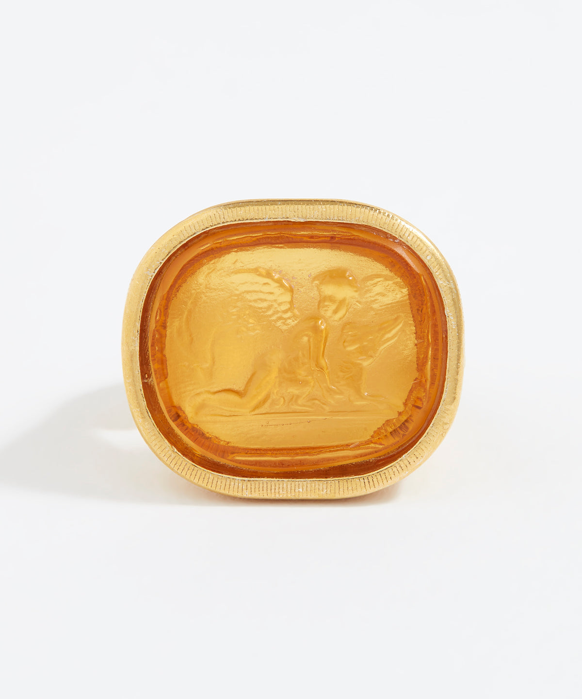 Gold ring with engraved design on a white background