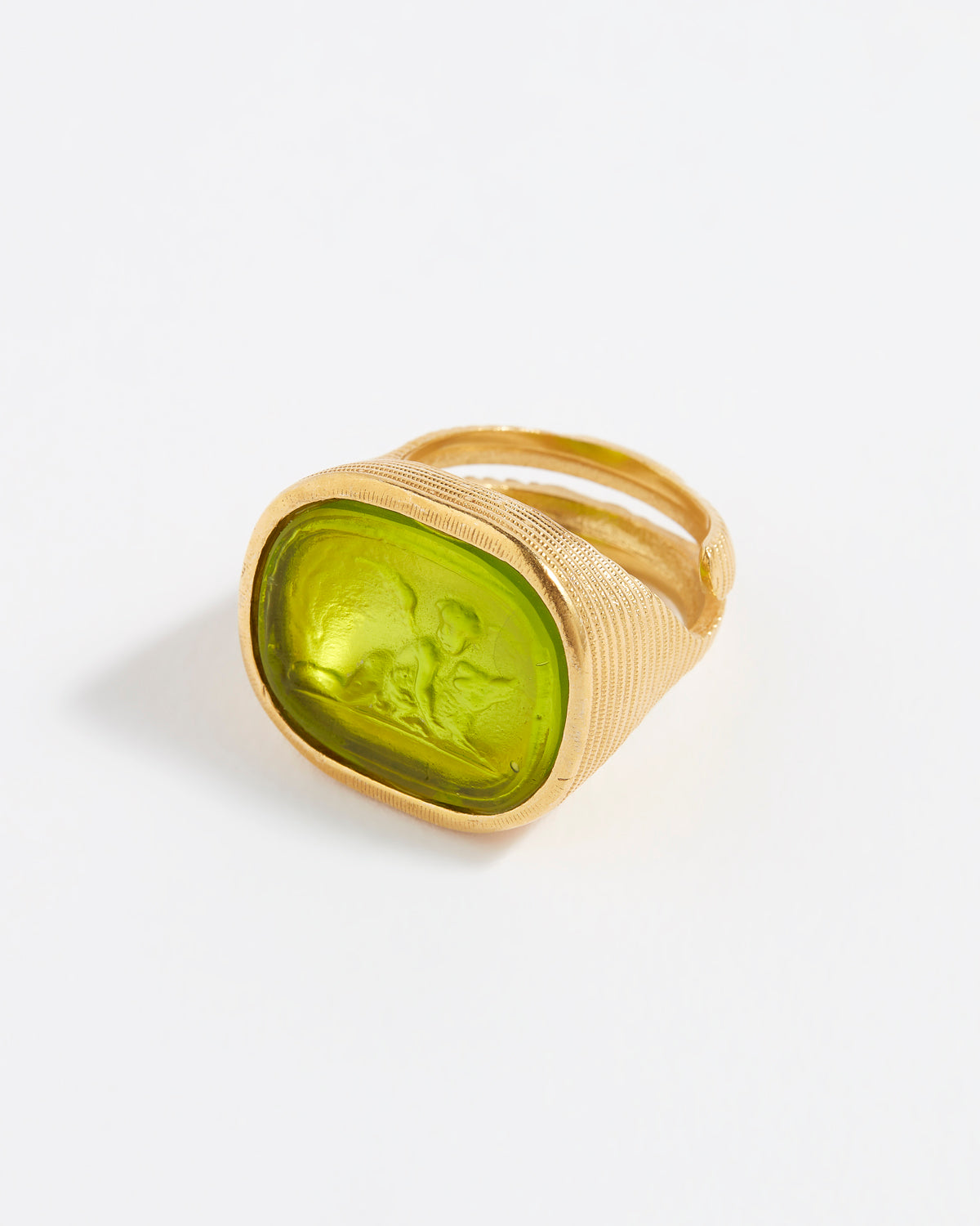 Gold ring with a green stone on a white background