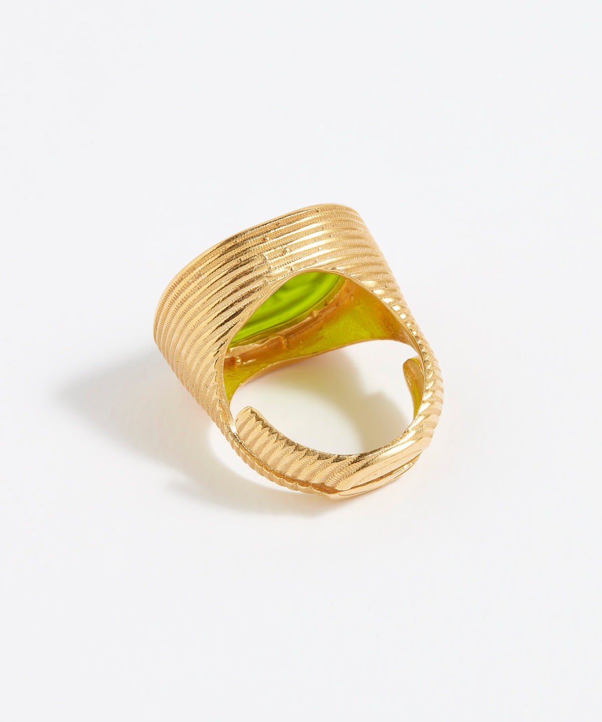 Gold ring with a green stone on a white background