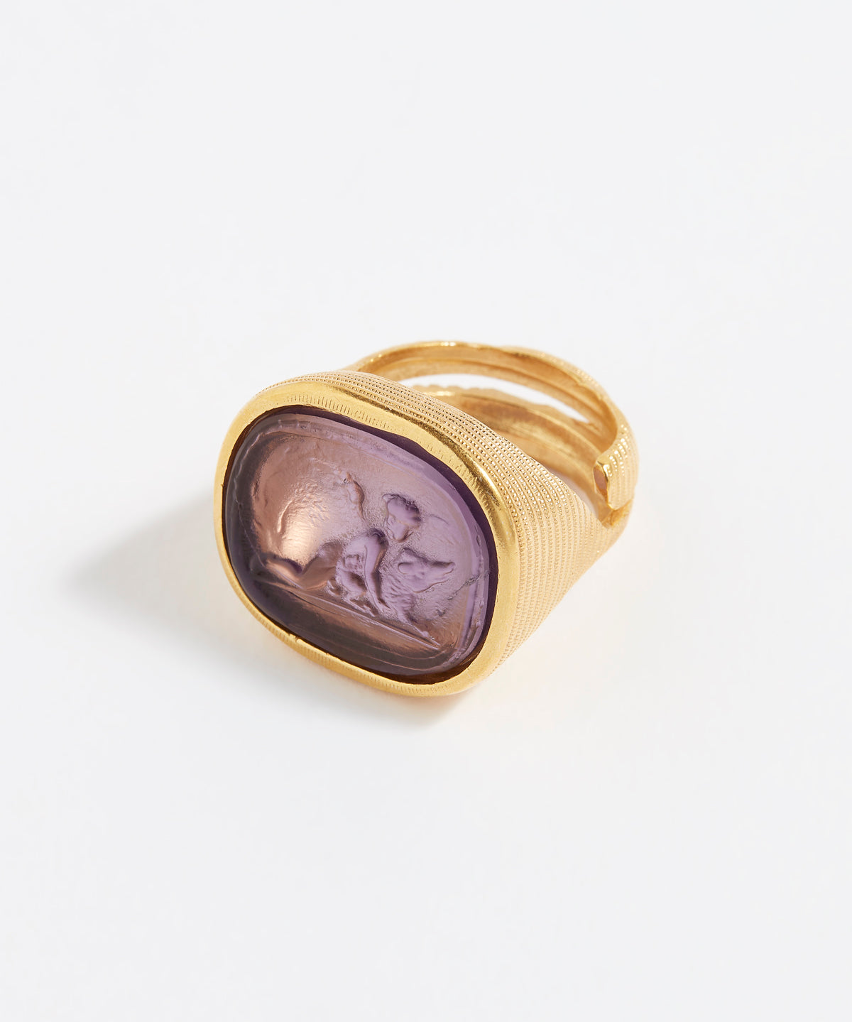 Gold ring with a purple stone on a white background