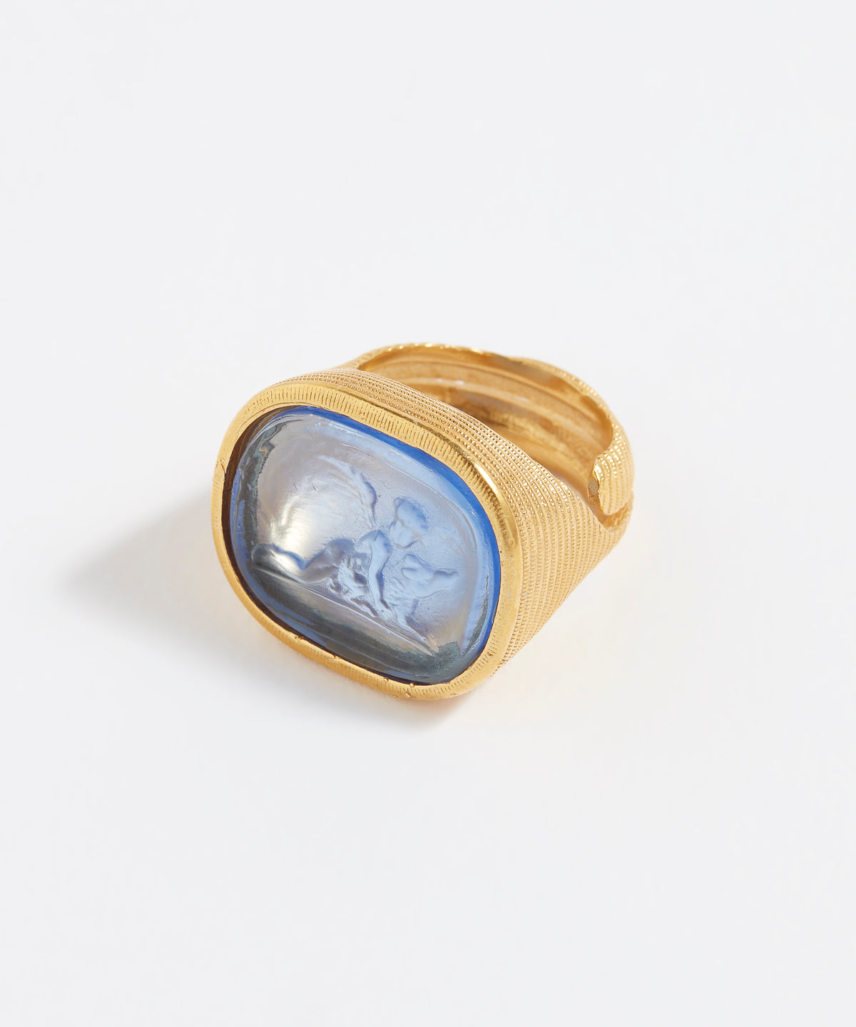 Gold ring with a blue stone on a white background