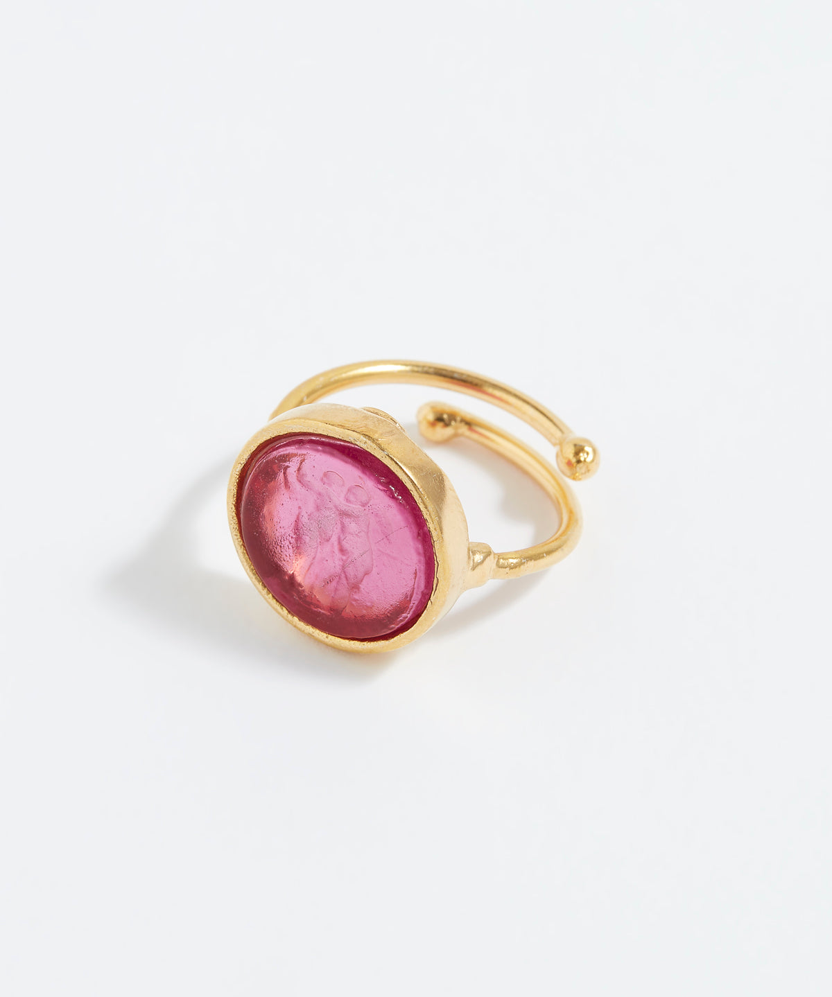 Gold ring with a pink stone on a white background