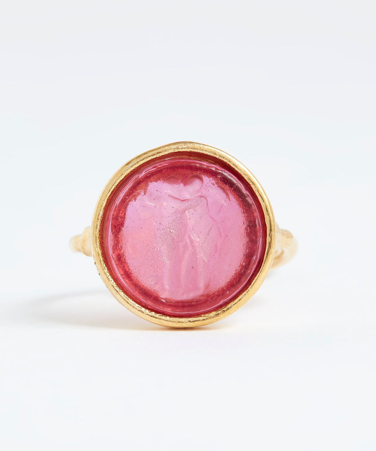 Gold ring with a pink stone on a white background