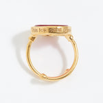 Gold ring with engraved text "This Too Shall Pass" on a white background