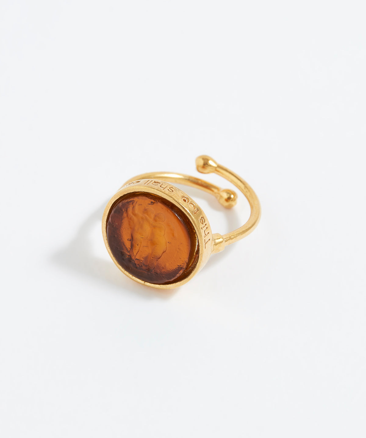 Gold ring with a topaz stone on a white background