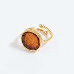 Gold ring with a topaz stone on a white background