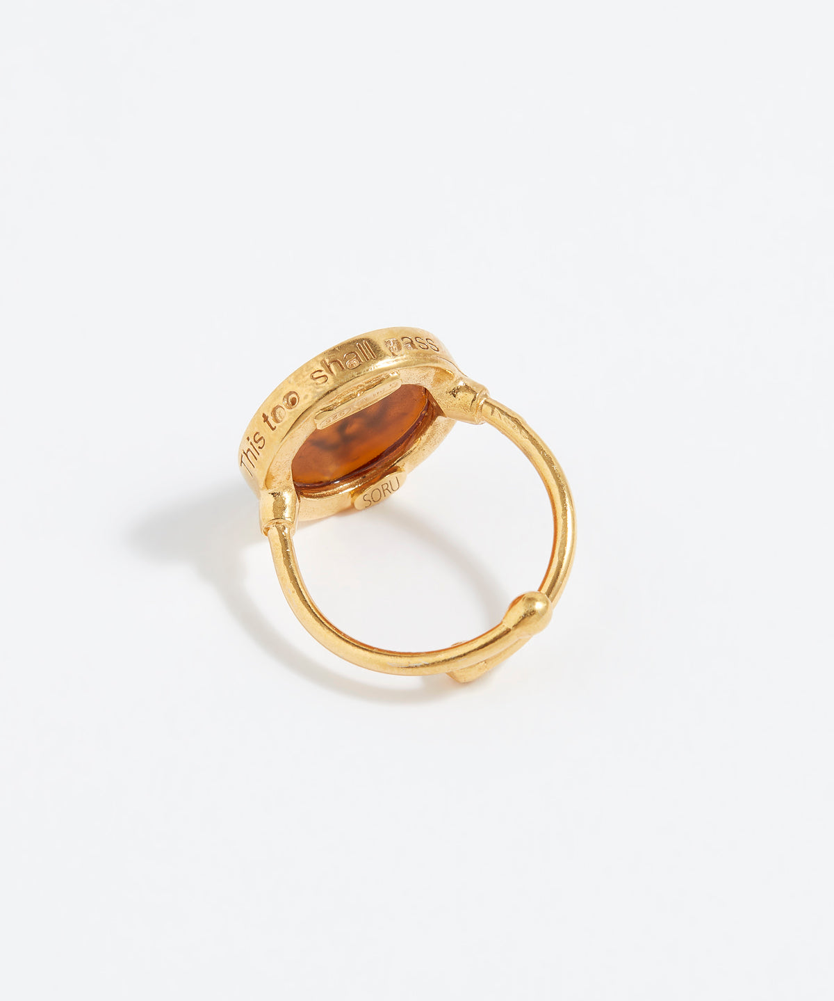 Gold ring with a circular design on a white background