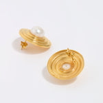Gold earrings with pearl centers on a white background, showing back of earring