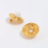 Gold earrings with pearl centers on a white background, showing back of earring