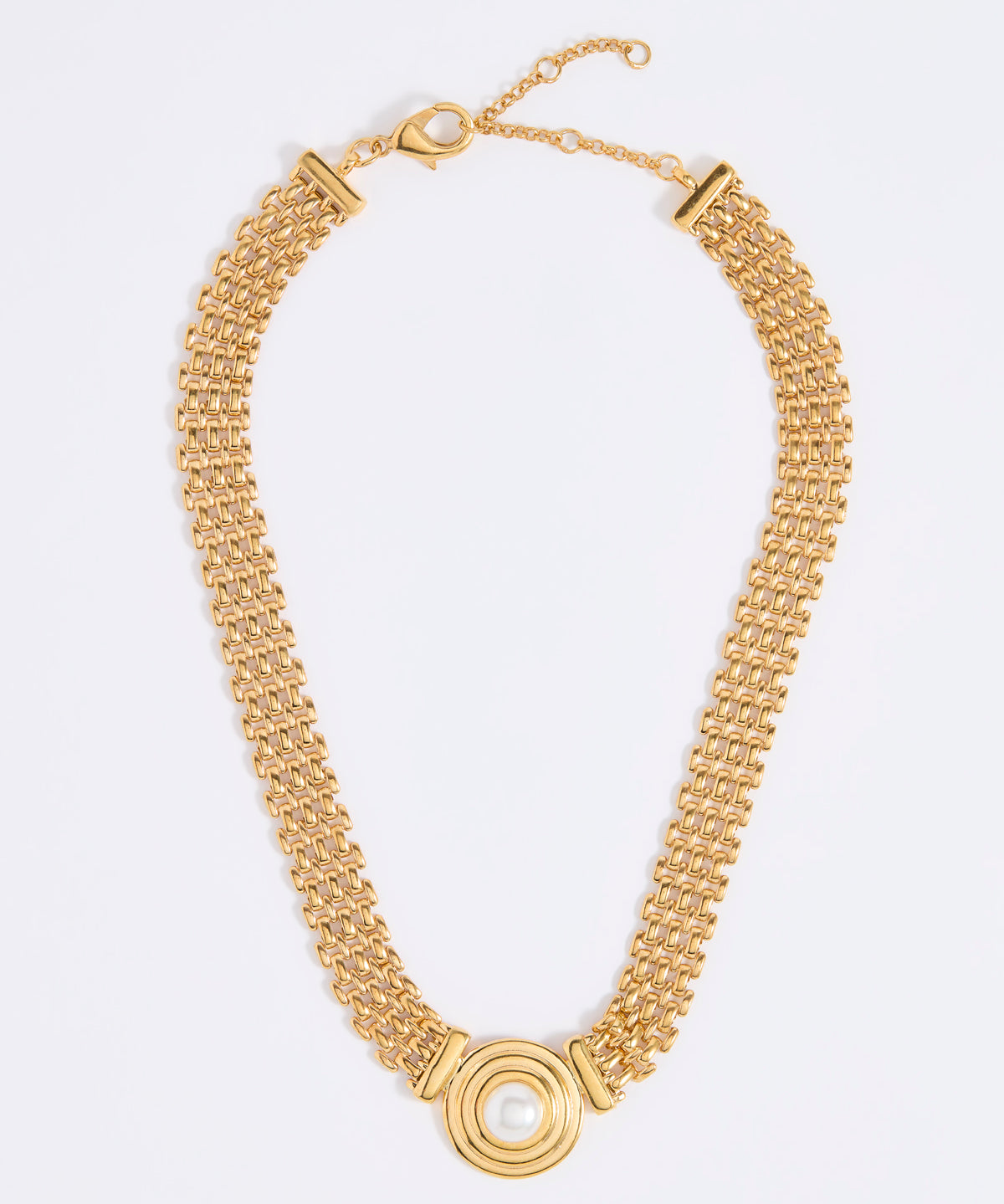 Gold chain necklace with a central pendant featuring a round pearl, on a white background