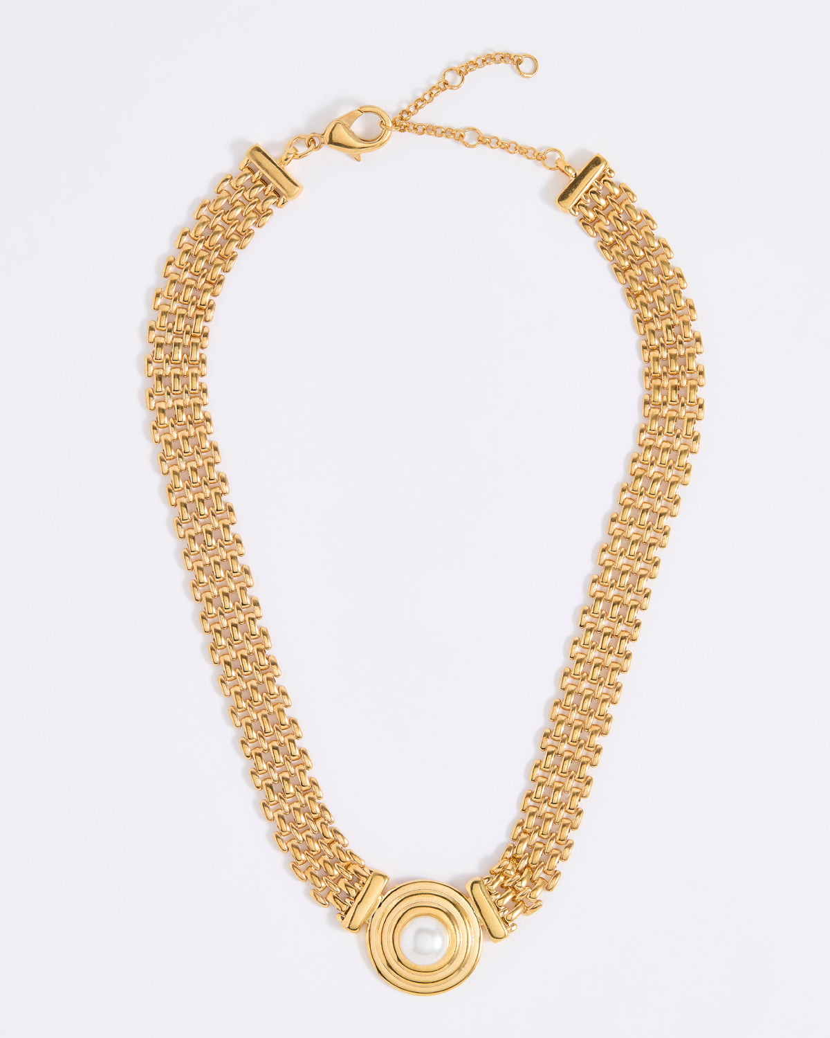 Gold chain necklace with a central pendant featuring a round pearl, on a white background