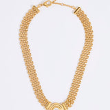 Gold chain necklace with a central pendant featuring a round pearl, on a white background