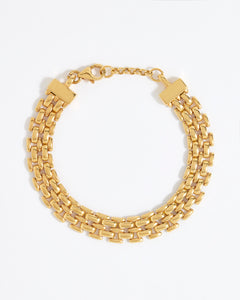 Gold chain bracelet on a white background