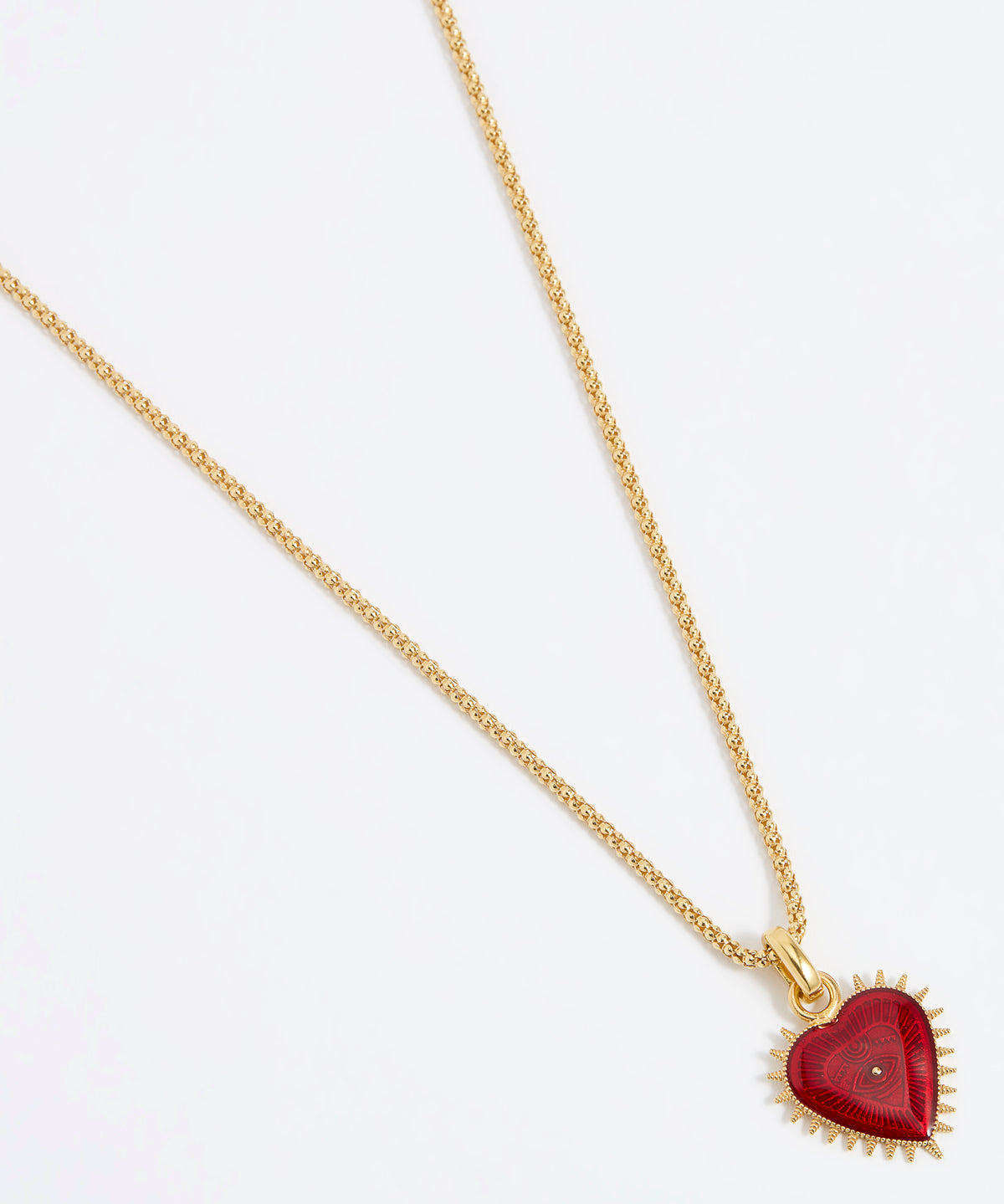 Product shot of Soru Jewellery red heart charm hung from a rope charm chain on white background