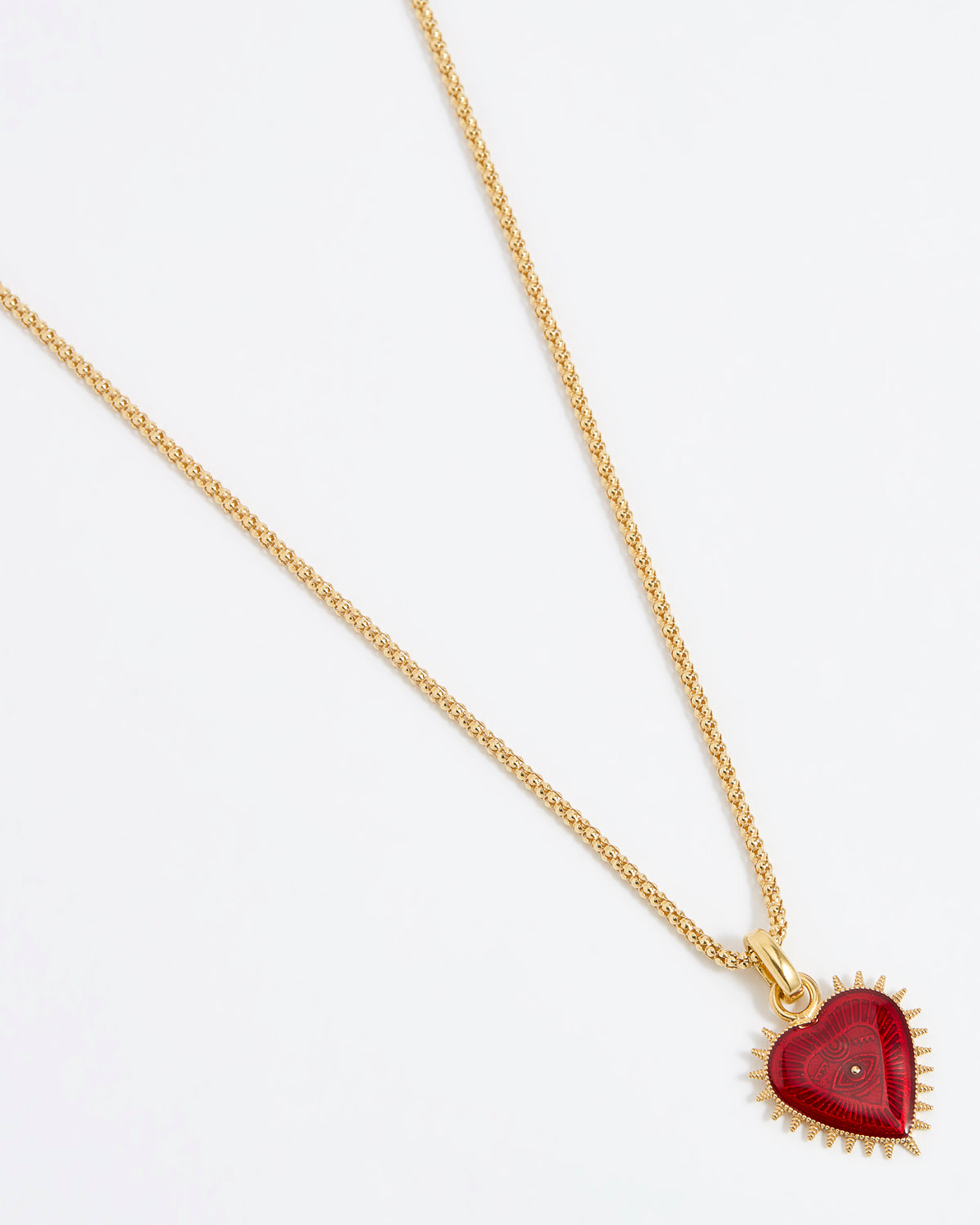 Product shot of Soru Jewellery red heart charm hung from a rope charm chain on white background